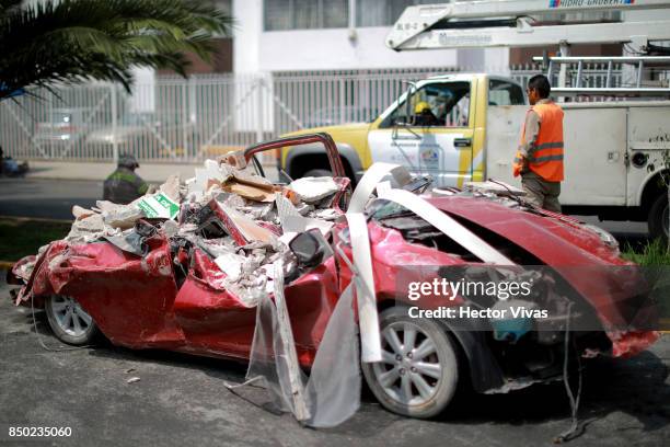 Car is seen destroyed due to the rubble from a collapsed building a day after the magnitude 7.1 earthquake jolted central Mexico killing more than...