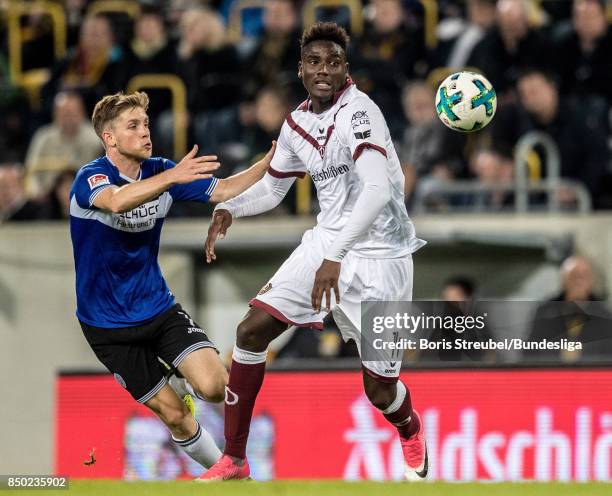 Peniel Mlapa of SG Dynamo Dresden in action with Patrick Weihrauch of Arminia Bielefeld during the Second Bundesliga match between SG Dynamo Dresden...