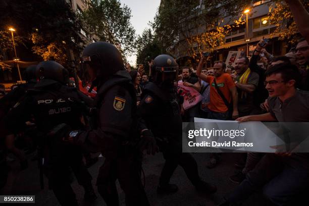 Demonstrators clash with Spanish National Police officers as they leave the road outside the Catalan Pro-Independence Lefty party CUP headquarters on...