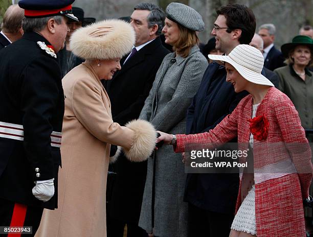 Britain's Queen Elizabeth II shakes hands with Marie-France van Heel, wife of Britain's Minister of Culture, Media and Sport Andy Burnham as they...