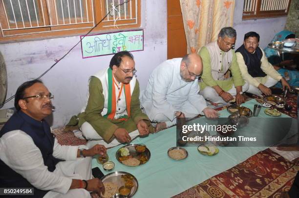 Munne Singh’s wife serves lunch to BJP National President Amit Shah at her house during his two days visit on September 20, 2017 in Dehradun, India.