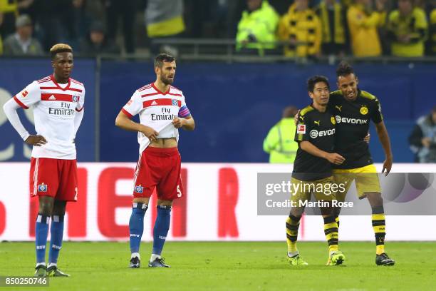 Gideon Jung of Hamburg , Mergim Mavraj of Hamburg and goal scorers Shinji Kagawa of Dortmund and Pierre-Emerick Aubameyang of Dortmund during the...