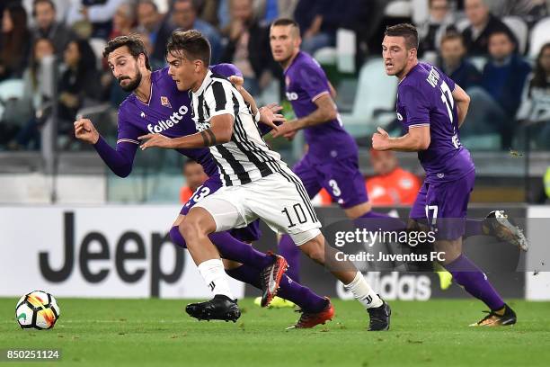 Paulo Dybala of Juventus and Davide Astori of fiorentina competes for the ball during the Serie A match between Juventus and ACF Fiorentina on...