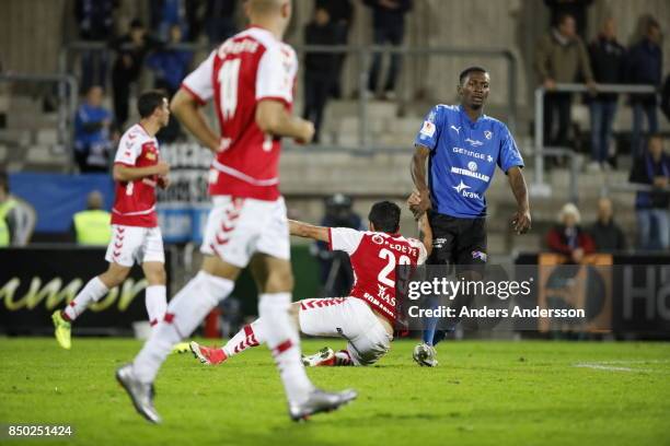 Aboubakar Keita of Halmstad BK helps Romario Pereira Sipiao of Kalmar FF to his feet at Orjans Vall on September 20, 2017 in Halmstad, Sweden.