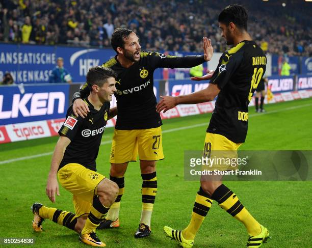 Christian Pulisic of Dortmund celebrates with Gonzalo Castro of Dortmund and Mahmoud Dahoud of Dortmund after he scored his teams third goal to make...