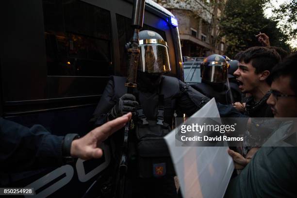 Demonstrators clash with Spanish National Police officers as they leave the road outside the Catalan Pro-Independence Lefty party CUP headquarters on...