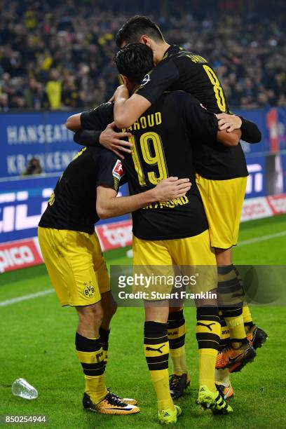 Christian Pulisic of Dortmund celebrates with Gonzalo Castro of Dortmund and Mahmoud Dahoud of Dortmund after he scored his teams third goal to make...
