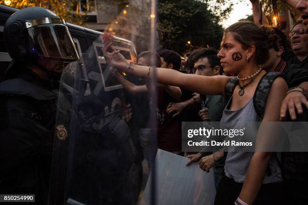 Demonstrators clash with Spanish National Police officers as they leave the road outside the Catalan Pro-Independence Lefty party CUP headquarters on...