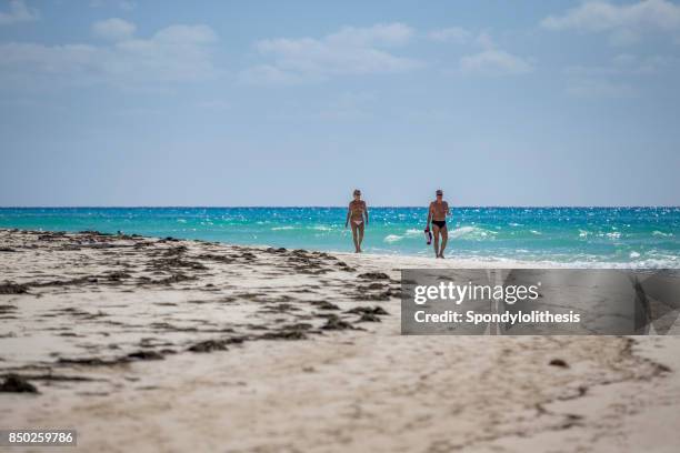 two tourists at the beach of cayo largo, cuba - varadero beach stock pictures, royalty-free photos & images