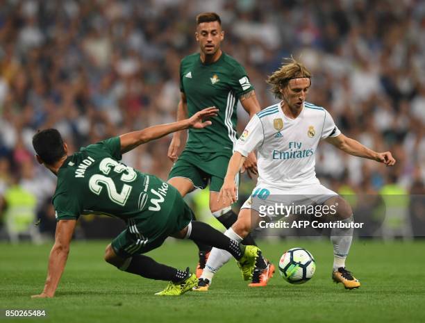 Real Madrid's midfielder from Croatia Luka Modric vies with Real Betis' defender from Algeria Aissa Mandi during the Spanish league football match...