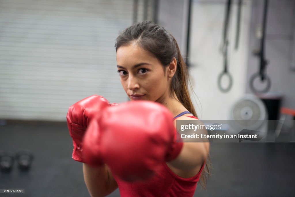 Young woman boxing in a gym