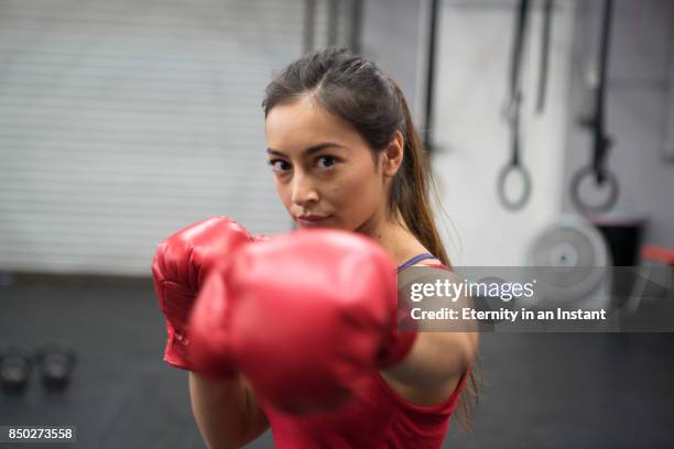young woman boxing in a gym - red glove stock pictures, royalty-free photos & images