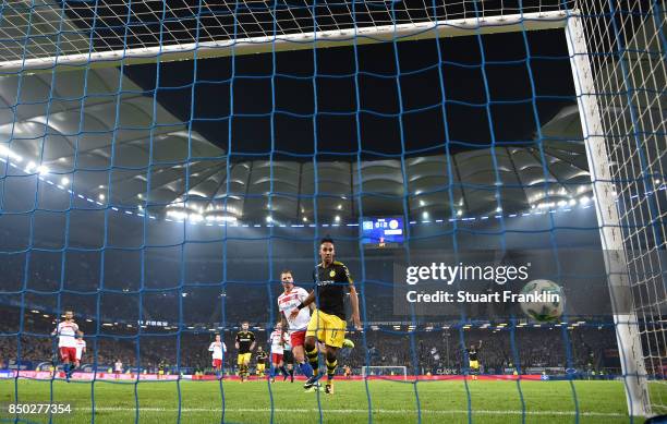 Pierre-Emerick Aubameyang of Dortmund watches the ball as Christian Pulisic of Dortmund scores Dortmunds third goal to make it 3:0 during the...