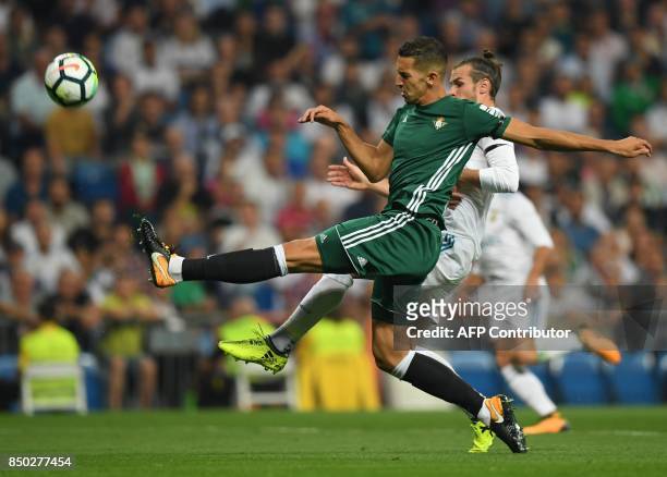 Real Betis' defender from Morocco Zou vies with Real Madrid's forward from Wales Gareth Bale during the Spanish league football match Real Madrid CF...