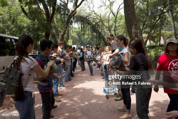 People gather to help following a deadly earthquake that struck Tuesday, on September 20, 2017 in Mexico City, Mexico. The death toll from the 7.1...