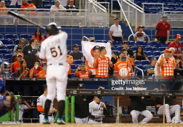 Fans of Ichiro Suzuki of the Miami Marlins are shown in the stands as he came up to pinch hit in the eighth inning of play against the New York Mets...
