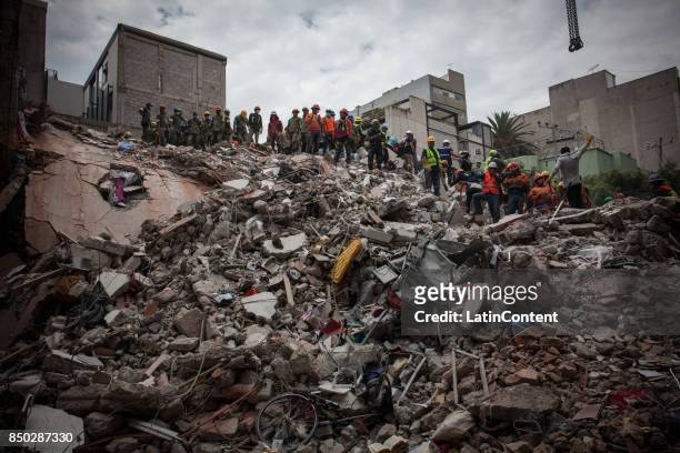 Rescuers work at a destroyed building at Colonia Condesa a day after the magnitude 7.1 earthquake jolted central Mexico killing more than 200 hundred...