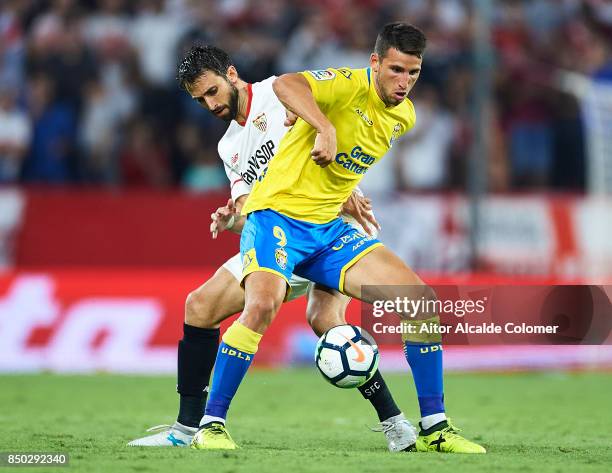 Nicolas Pareja of Sevilla FC competes for the ball with Jonathan Calleri of Union Deportiva Las Palmas during the La Liga match between Sevilla and...