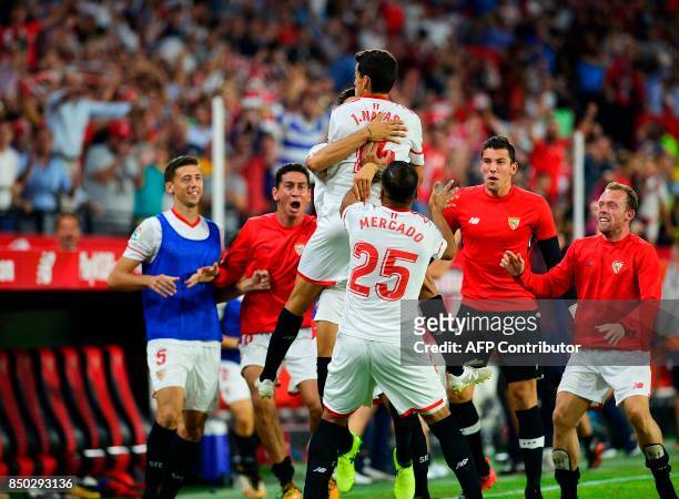 Sevilla's midfielder Jesus Navas celebrates a goal with teammates during the Spanish league football match Sevilla FC against UD Las Palmas at the...