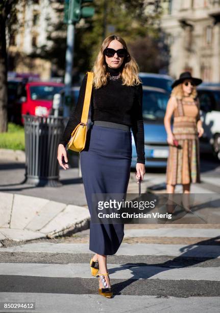 Candela Novembre wearing navy skit, yellow bag, longshirt is seen outside Alberta Ferretti during Milan Fashion Week Spring/Summer 2018 on September...
