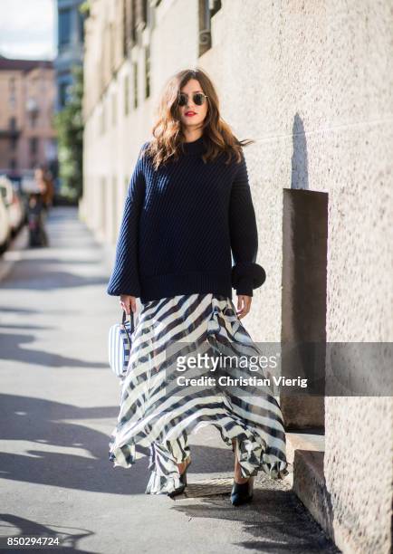 Eleonora Carisi wearing navy knit, striped skirt is seen outside Alberta Ferretti during Milan Fashion Week Spring/Summer 2018 on September 20, 2017...