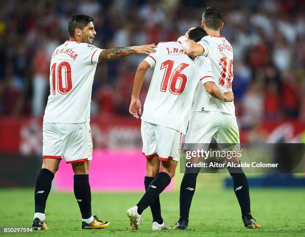 Jesus Navas of Sevilla FC celebrates after scoring with Ever Banega of Sevilla FC and Sergio Escudero of Sevilla FC during the La Liga match between...