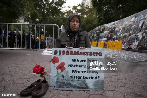 Demonstrator hold a sign during a protest against Hassan Rouhani, Iran's president, not pictured, outside the UN General Assembly meeting in New...