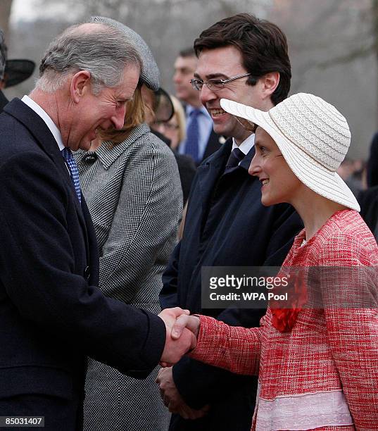Britain's Minister for Culture, Media and Sport Andy Burnham looks on as his wife Marie-France van Heel shakes hands with Prince Charles, the Prince...