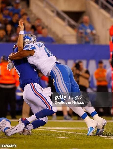 Cornelius Washington of the Detroit Lions tackles Eli Manning of the New York Giants on September 18, 2017 at MetLife Stadium in East Rutherford, New...