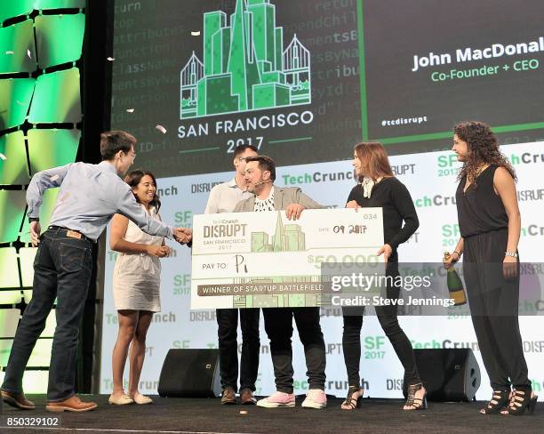 Pi Co-Founder and CTO Lixin Shi and Pi Co-Founder and CEO John MacDonald win the Startup Battlefield finals and are presented with a check from...