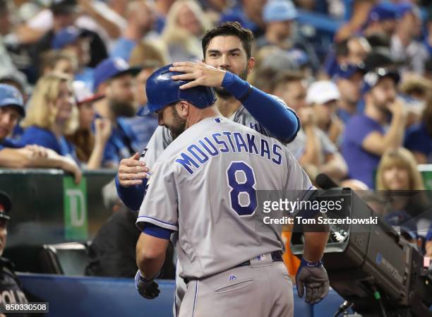 Mike Moustakas of the Kansas City Royals is congratulated by Eric Hosmer after hitting a solo home run in the sixth inning, setting a club record...