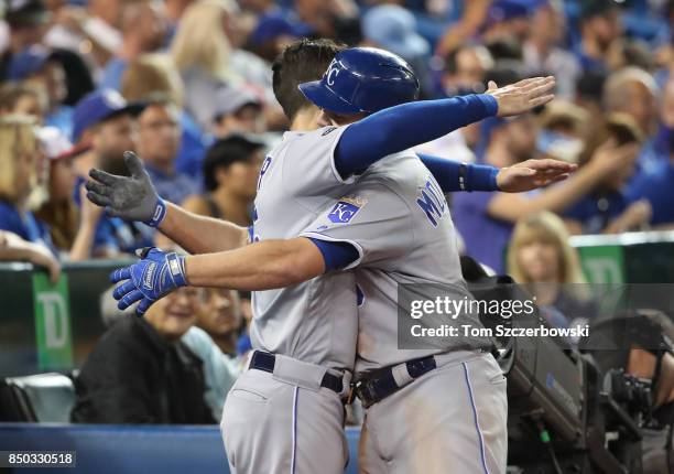 Mike Moustakas of the Kansas City Royals is congratulated by Eric Hosmer after hitting a solo home run in the sixth inning, setting a club record...