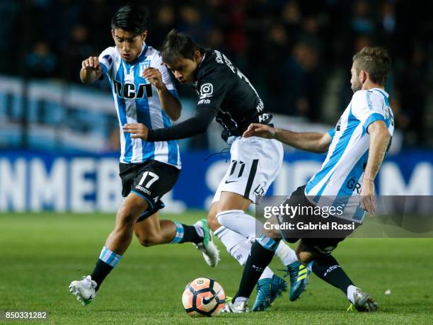 Angel Romero of Corinthians fights for the ball with Leandro Grimi of Racing Club during a second leg match between Racing Club and Corinthians as...