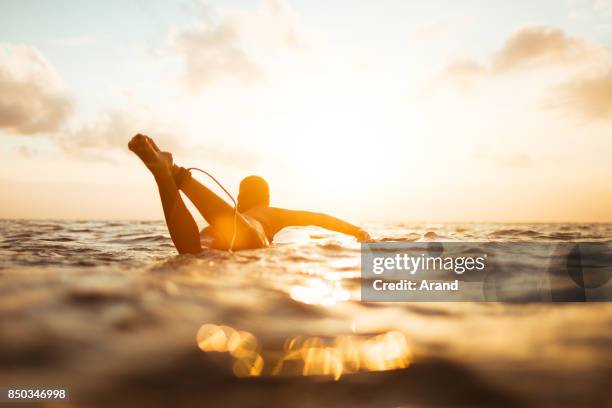 young surfer woman - using a paddle stock pictures, royalty-free photos & images