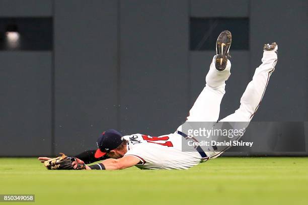 Lane Adams of the Atlanta Braves makes a diving catch during the third inning against the Washington Nationals at SunTrust Park on September 20, 2017...