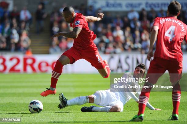 Southampton's Nathaniel Clyne jumps a tackle by Pablo Hernandez during the Barclays Premier League match at the Liberty Stadium, Swansea.