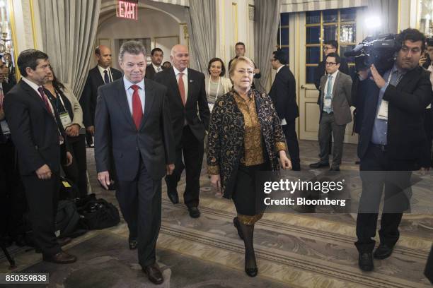 Juan Manuel Santos, Colombia's president, center left, and Michelle Bachelet, Chile's president, center right, are followed by Eduardo Ferreyros,...