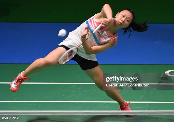 Zhang Beiwen of the US hits a return towards Sonia Cheah of Malaysia during their women's singles second round match at Japan Open Badminton...