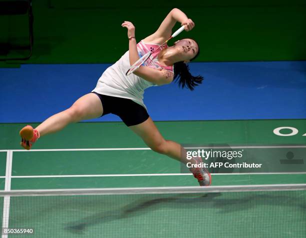 Zhang Beiwen of the US hits a return towards Sonia Cheah of Malaysia during their women's singles second round match at Japan Open Badminton...