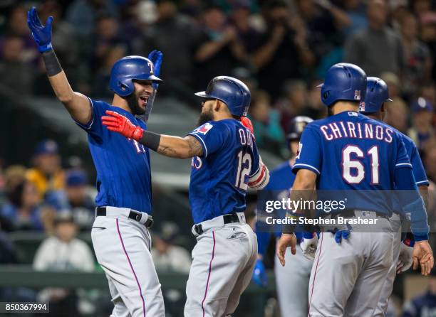 Nomar Mazara of the Texas Rangers greets Rougned Odor after Odor hit a grand slam home run off of relief pitcher Andrew Albers of the Seattle...