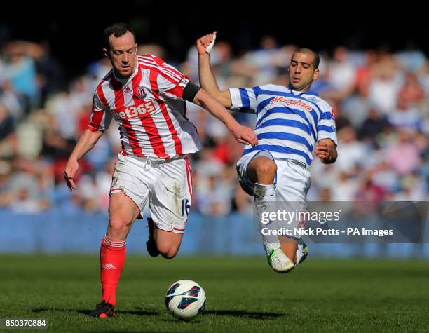 Stoke City's Charlie Adam runs away from the Queens Park Rangers defender Tal Ben Haim last ditch tackle during the Barclays Premier League match at...