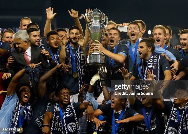 Matt Besler and Sporting Kansas City celebrate with the trophy after they defeated New York Red Bulls 2-1 to win the 2017 U.S Open Cup Final at...