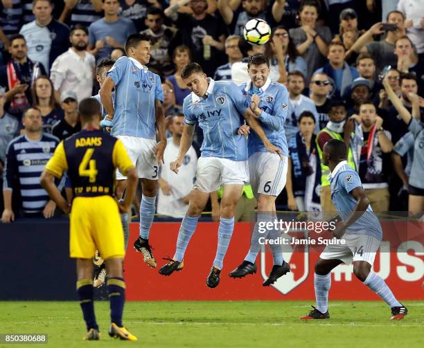 Daniel Salloi, Matt Besler, and Ilie Sanchez of Sporting Kansas City deflect a free kick during the 2017 U.S Open Cup Final against the New York Red...