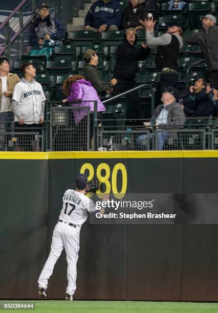 Fan catches a grand slam home run ball hit by Rougned Odor of the Texas Rangers off of relief pitcher Andrew Albers of the Seattle Mariners as right...