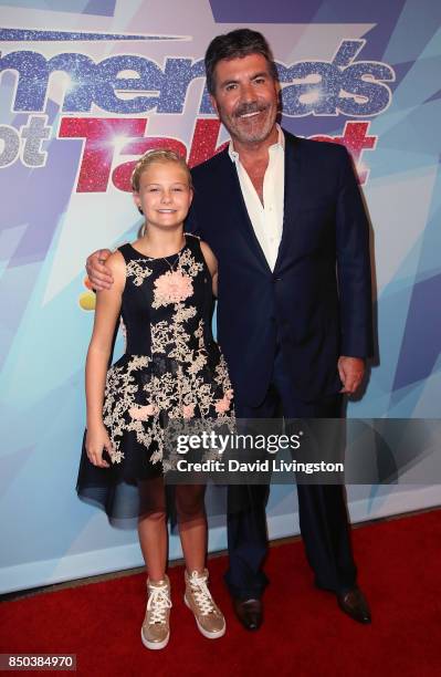 Season 12 winner ventriloquist Darci Lynne Farmer and judge/executive producer Simon Cowell attend NBC's "America's Got Talent" season 12 finale at...