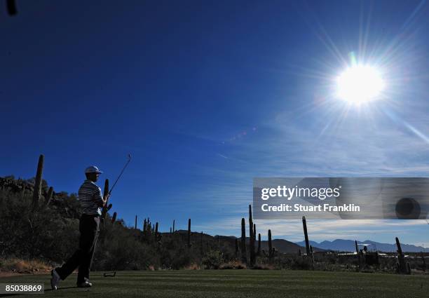 Tiger Woods of the USA plays his tee shot during practice prior to the start of the Accenture Match Play Championships at Ritz - Carlton Golf Club at...