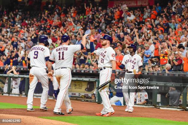 Houston Astros Catcher Evan Gattis and Houston Astros Infielder Marwin Gonzalez are congratulated by Houston Astros Outfielder Derek Fisher after...