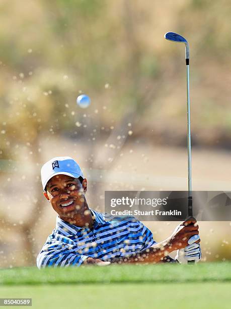 Tiger Woods of the USA hits a bunker shot during practice prior to the start of the Accenture Match Play Championships at Ritz - Carlton Golf Club at...