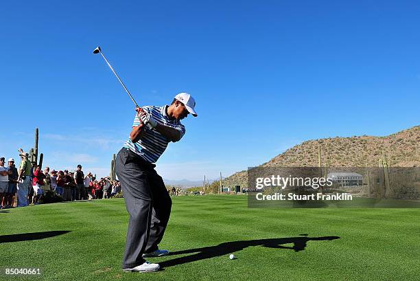 Tiger Woods of the USA plays his tee shot during practice prior to the start of the Accenture Match Play Championships at Ritz - Carlton Golf Club at...