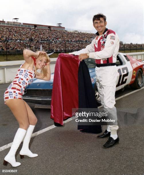 Driver Bobby Allison plays the Matador and Miss Winston, Bee Bop Hobel, plays the bull before the Coca-Cola 500 race on July 31, 1977 at the Pocono...